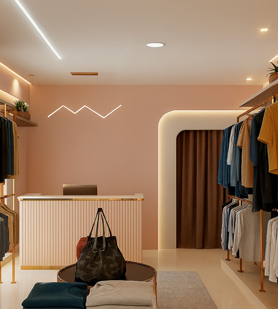 Modern boutique clothing store interior with warm beige walls, gold-accented clothing racks displaying neatly hung shirts, trousers, and jackets, a central checkout counter with a laptop, decorative indoor plants on upper shelves, and a cozy illuminated fitting room entrance.